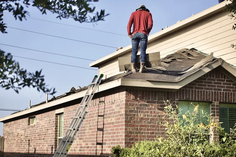 Professional roofer working on a residential roof in Hooverhurst
